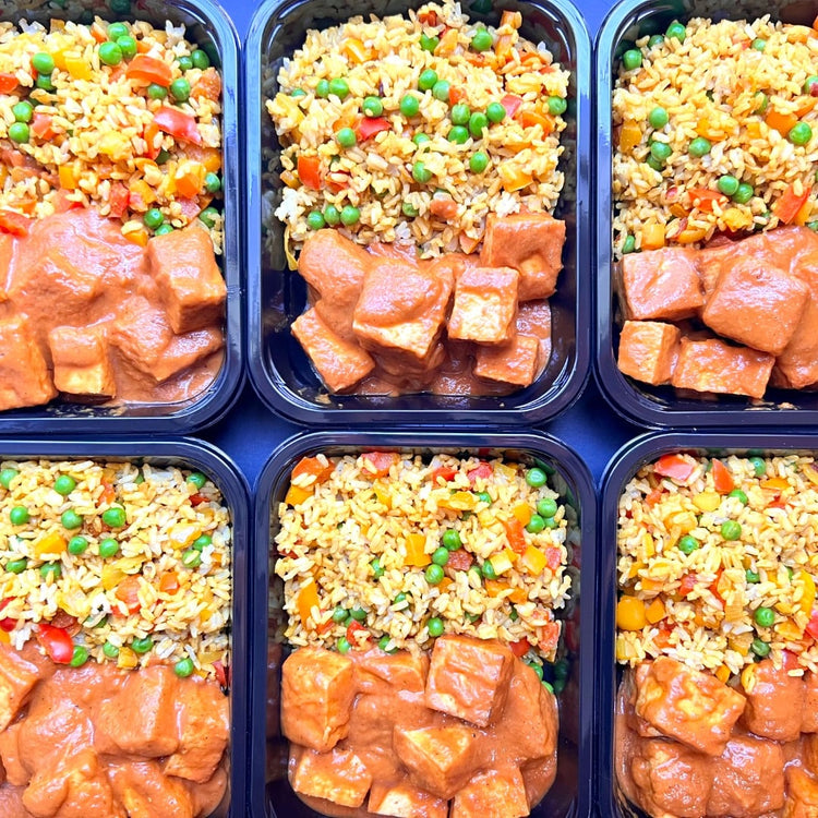 A set of healthy prepped meals in Fierce Fuel plastic containers, including Peri Peri Tofu and Mediterranean Rice.
