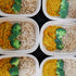Four ready-made plastic containers with Golden Red Lentil Daal from Fierce Fuel in them.