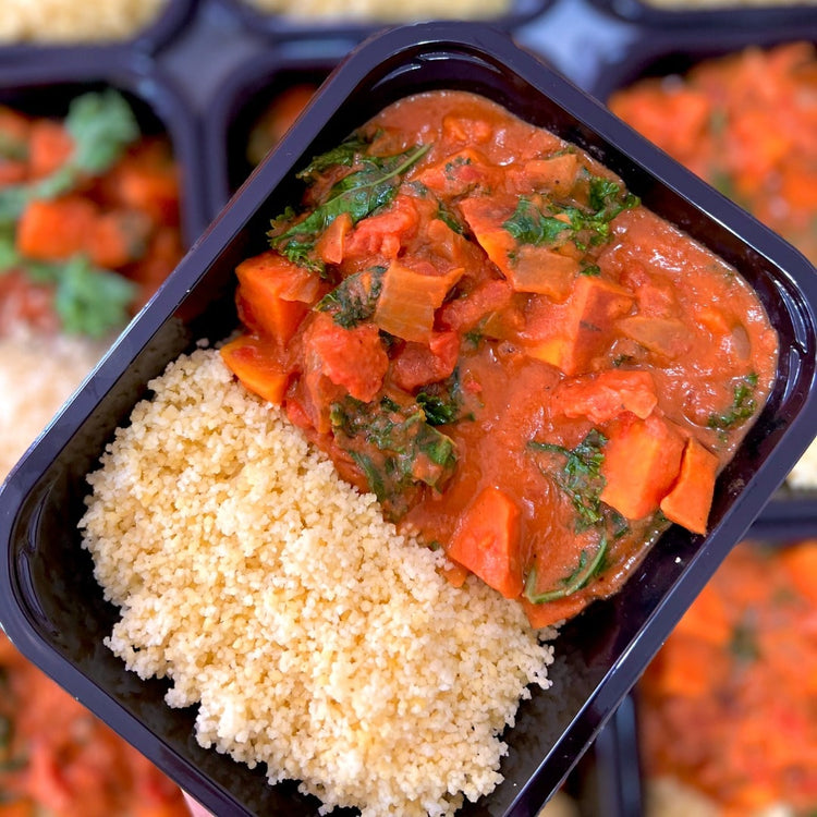 A ready-made bowl of African Peanut Sweet Potato Stew from Fierce Fuel, a Whistler-based healthy meals provider, served in a black container.