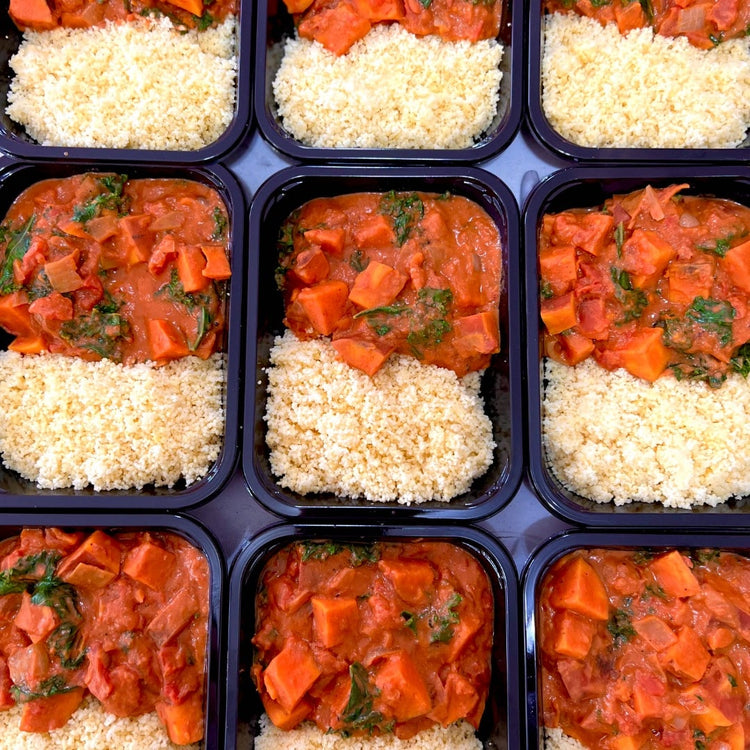 A tray of African Peanut Sweet Potato Stew with rice and carrots in it, made by Fierce Fuel. (Keywords: prepped meals)
