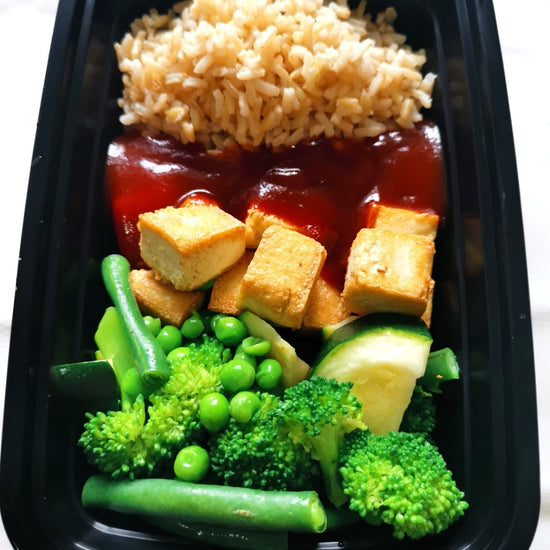 A ready-made prepped meal from Fierce Fuel in Squamish: Black container with BBQ Tofu, Brown Rice & Veggies.