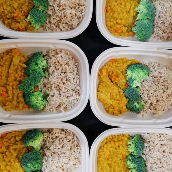Four ready-made plastic containers with Golden Red Lentil Daal from Fierce Fuel in them.