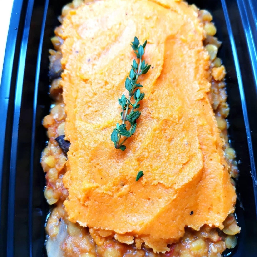 A prepped meal of Lentil & Mushroom Bake, carrots, and sprigs of thyme from Fierce Fuel located in Whistler.