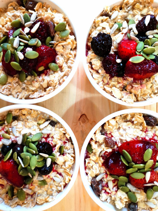 Four prepped bowls of Superfood Overnight Oats with berries and seeds from Fierce Fuel.